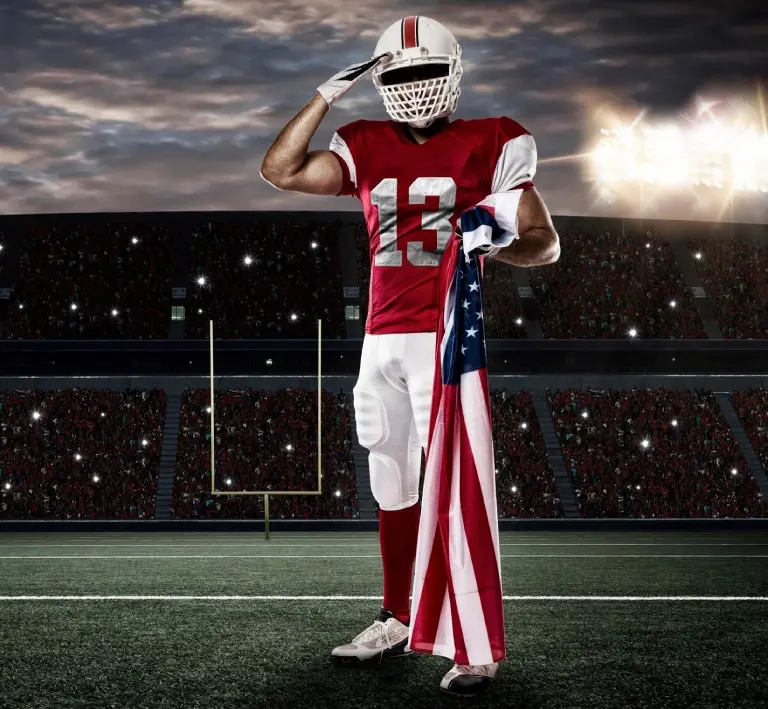 Football Player with a red uniform saluting with a American flag on Stadium